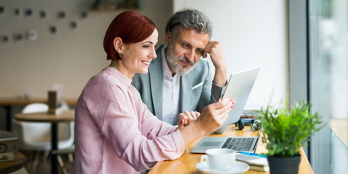 An older couple at a desk looking over types of financing