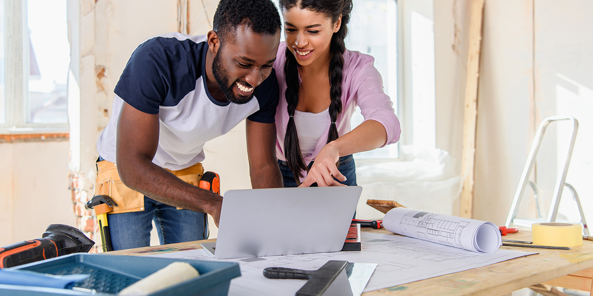 A couple in their fix and flip property looking up renovation instructions