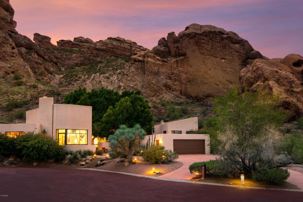 A beautiful home in front of desert backdrop.