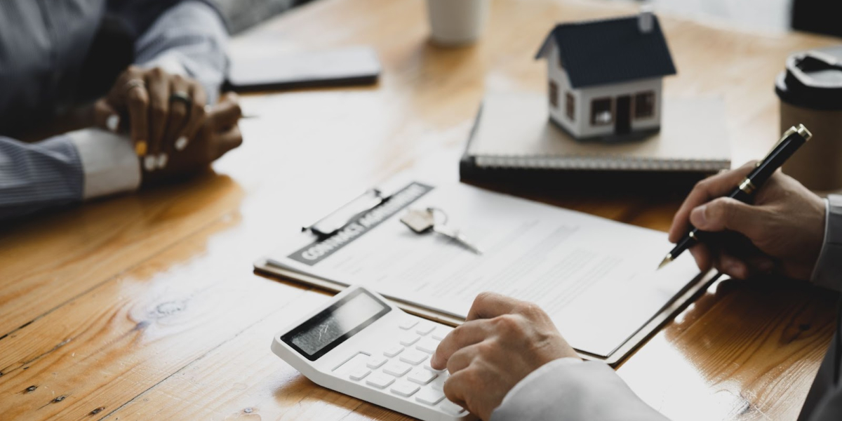 close up view of a lender going over paperwork with a real estate investor