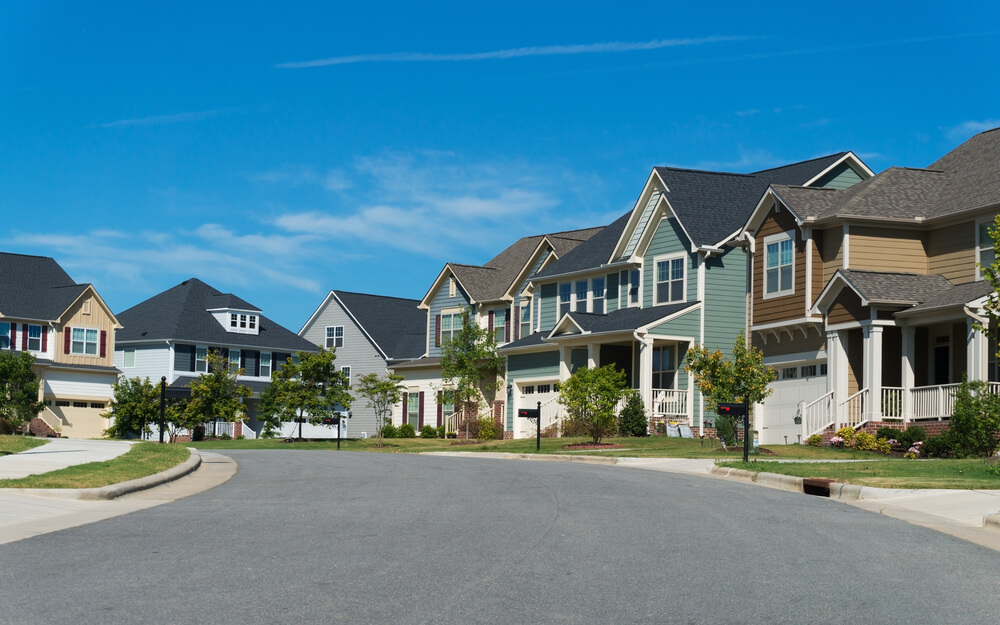 A pretty neighborhood with new houses and blue skies above.